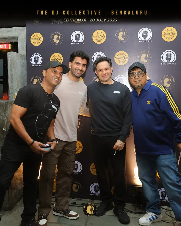 Four DJs lined up for a portrait, name badges on