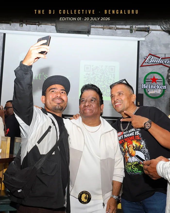 Three people crowding into a phone camera for a selfie
