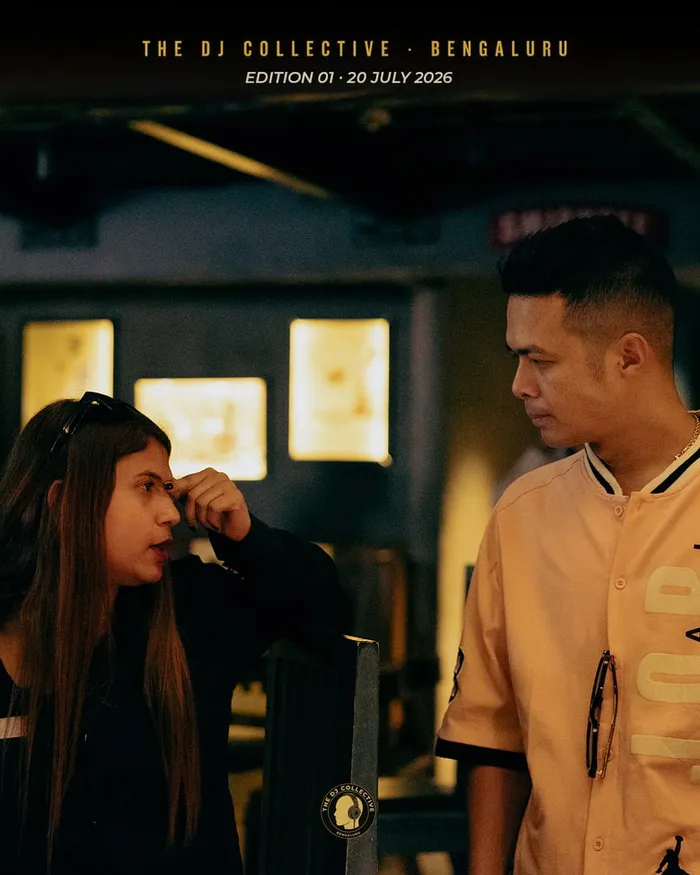 Two people talking at a table, one in a cream jacket