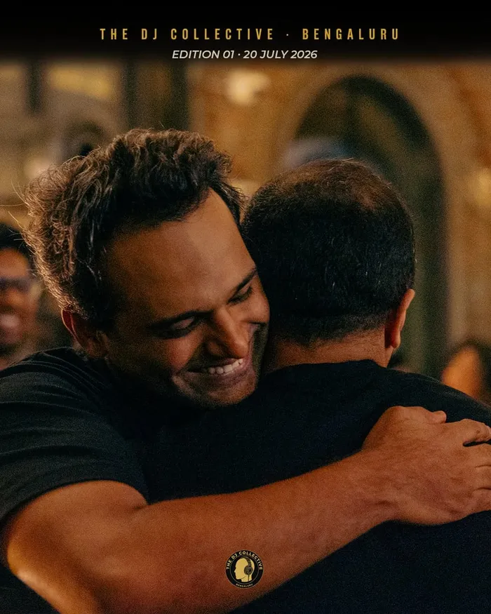 Two DJs hugging, a third smiling behind them