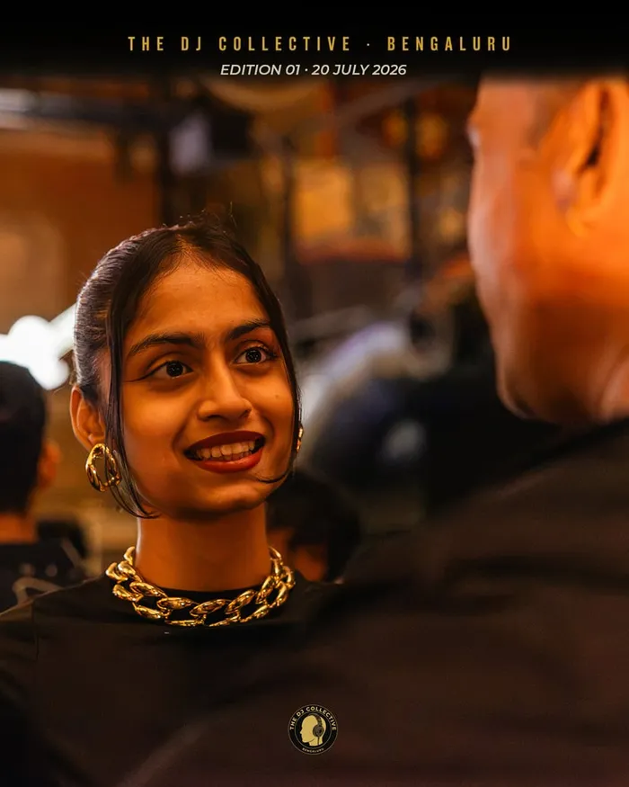 A DJ smiling in the middle of the crowd