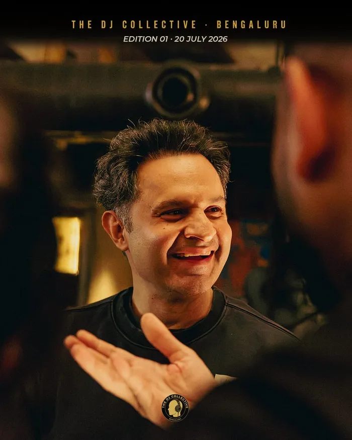 A DJ mid-gesture, grinning, in conversation