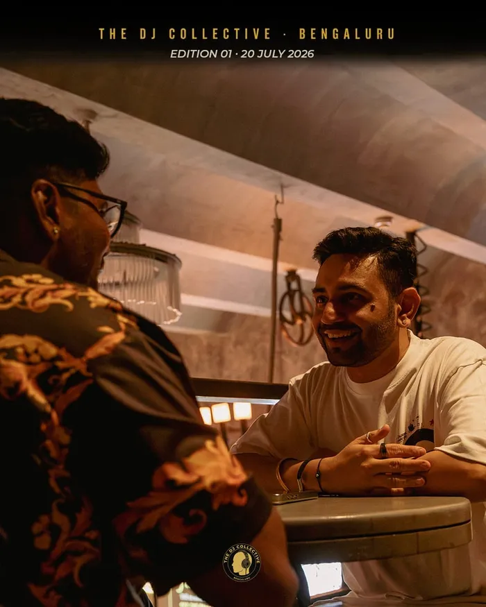 Two DJs talking over a table