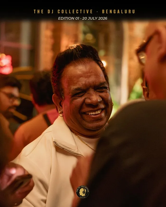A DJ in white laughing mid-conversation