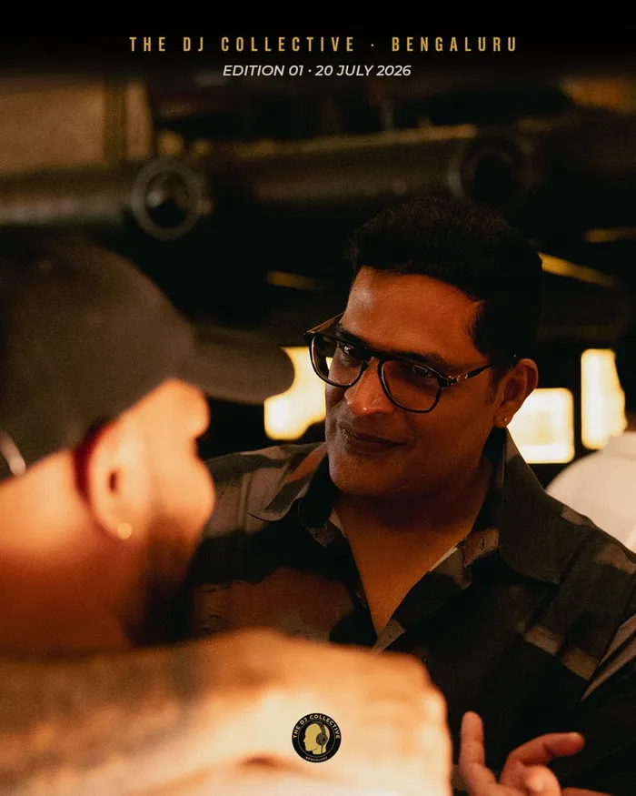 Two DJs talking and smiling in the crowd