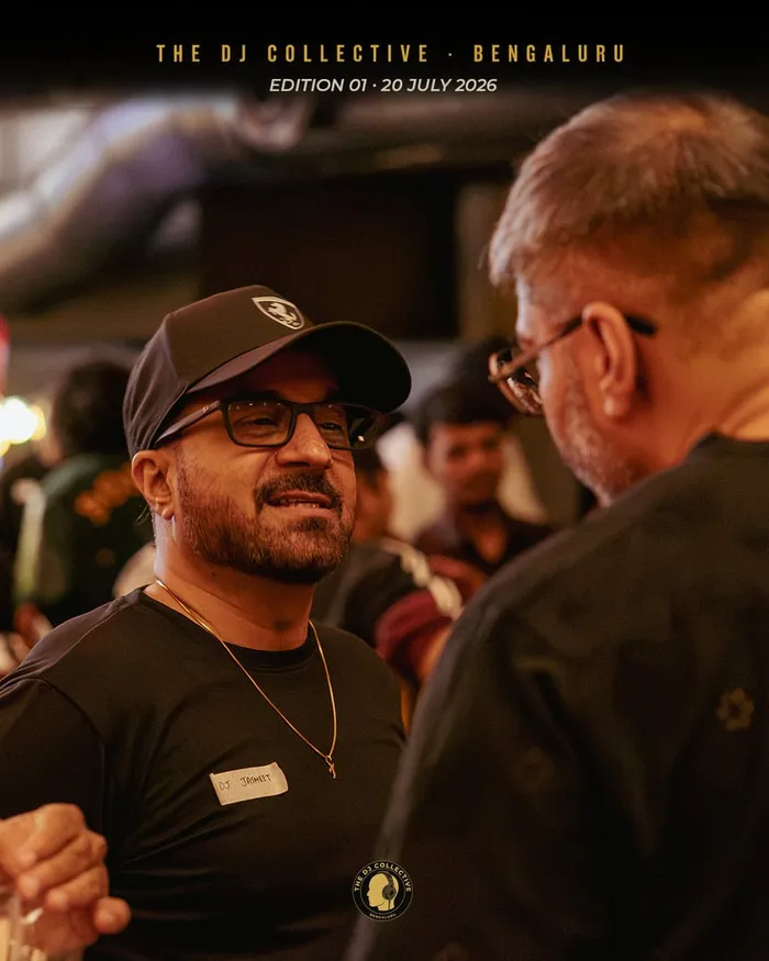 A group of DJs in conversation near the bar
