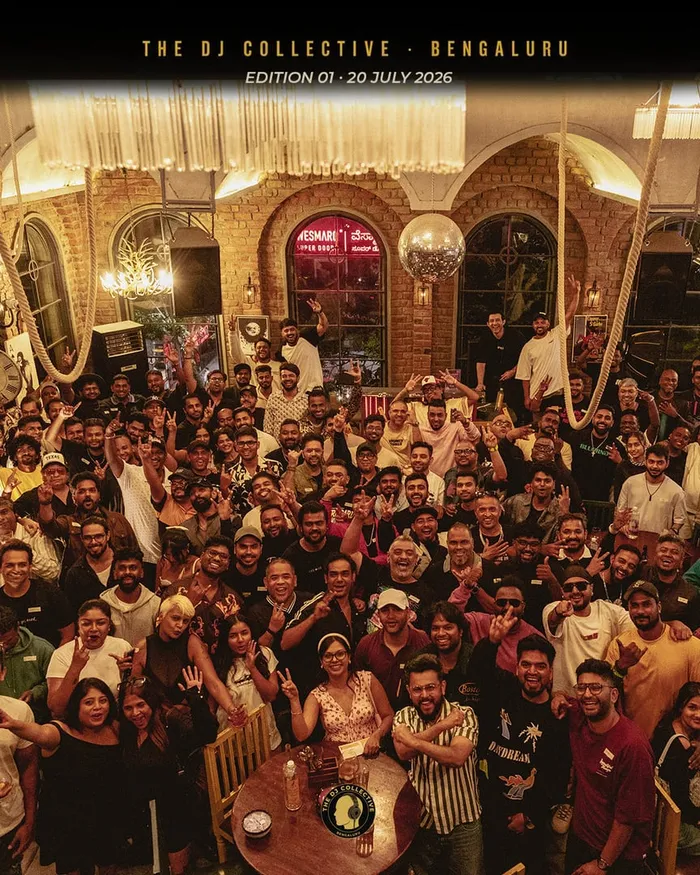 The whole room gathered for a group photo, arms raised